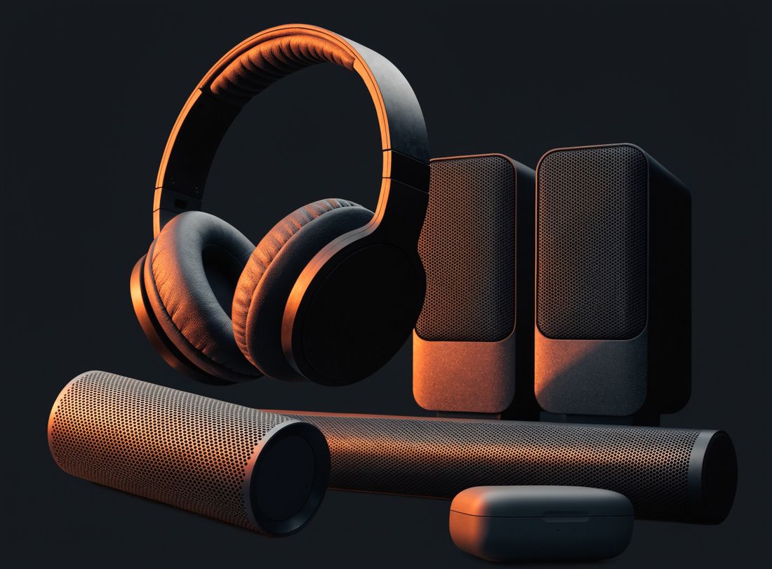 Over-ear headphones, a pair of desktop speakers, portable speakers and an earbud case