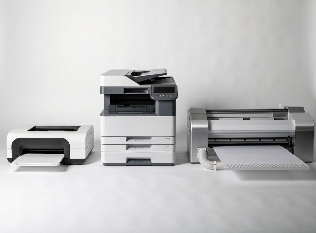 A home inkjet printer, an office multifunction printer and a wide-format printer side by side